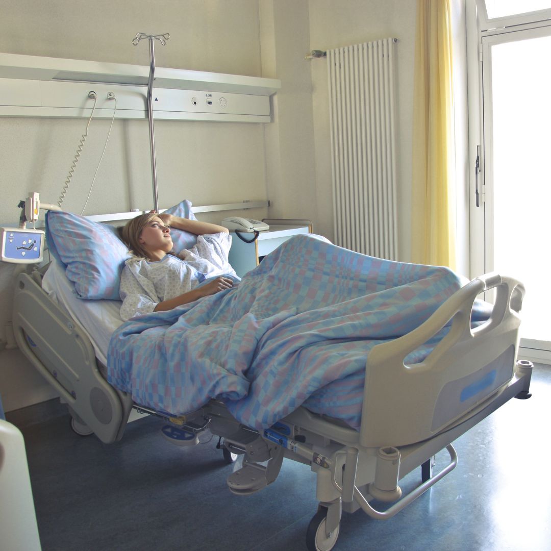Patient in hospital bed.